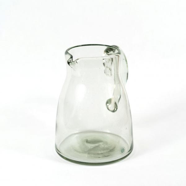 Handblown glass pitcher. Classically shaped. White background.
