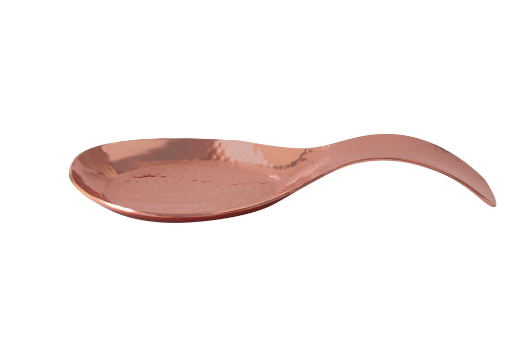 Hammered copper spoon rest on a white background.