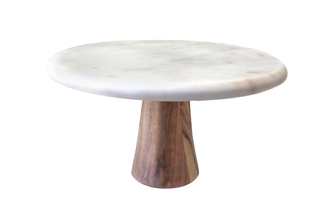 Cake stand with a white marble top and wood bottom. White background.