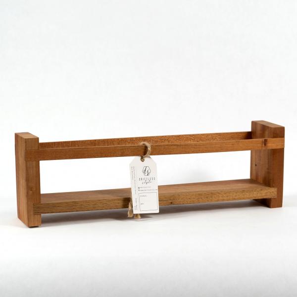 Handmade reclaimed wood caddy that is simple in design. Solid ends with two rails to hold any contents in place. White background.