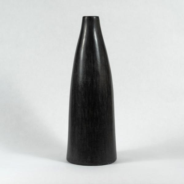 One tall slim dark gray Tadelakt vase. White background.