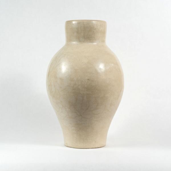 One large creamy ivory Tadelakt vase with a large belly that tapers to a smaller neck. White background.