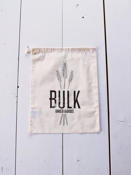 Organic cotton drawstring produce bag. Design says “Bulk Dried Goods” in brown ink. The text is in front of 3 illustrated wheat grains.