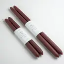 Pair of Hand-dipped 100% Beeswax 14 inch Taper Candles in Burgundy. Lays next to a 10 inch pair of beeswax taper candles.