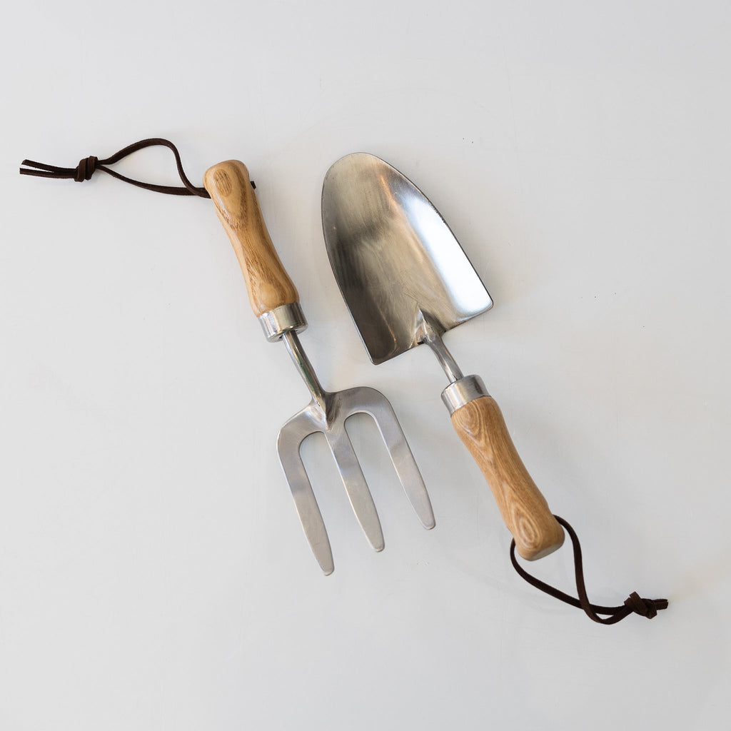Steel, wood, and leather children's garden tool set includes a trowel and a cultivator.