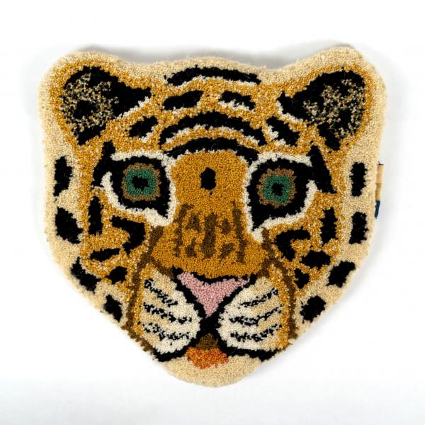 Hand-tufted wool rug shaped like a tiger head laying flat on a white background. A beautifully crafted and detailed tiger face.