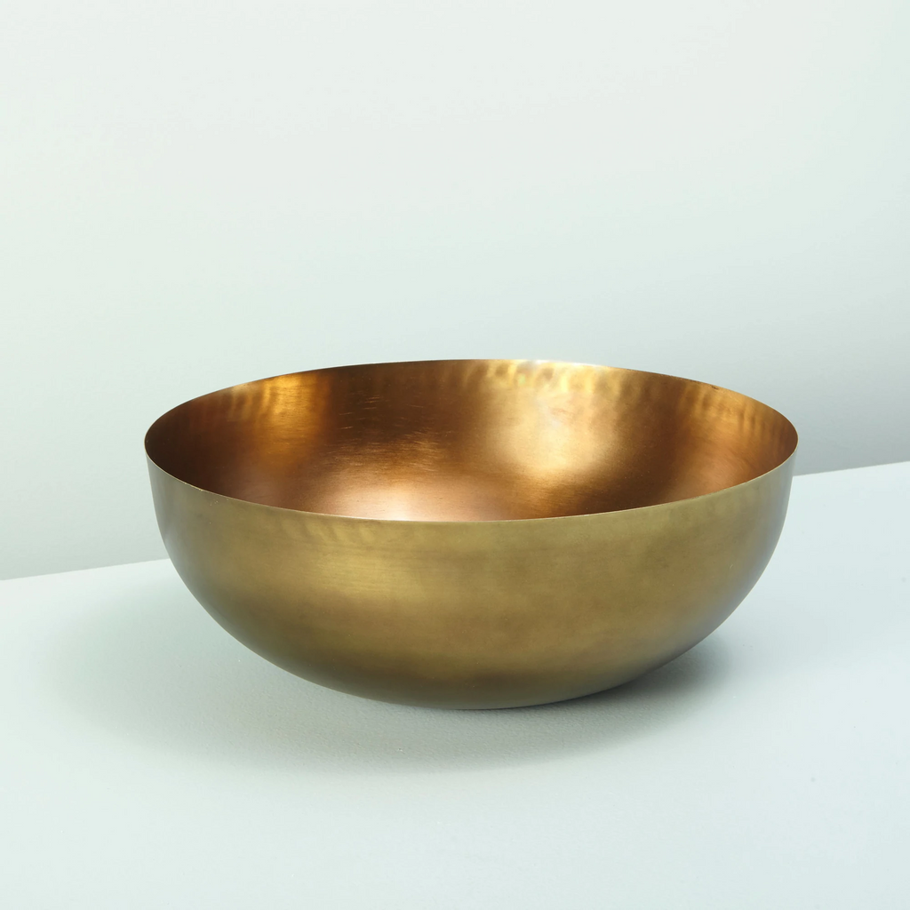 Cobbled antiqued bronze bowl on a gray background.