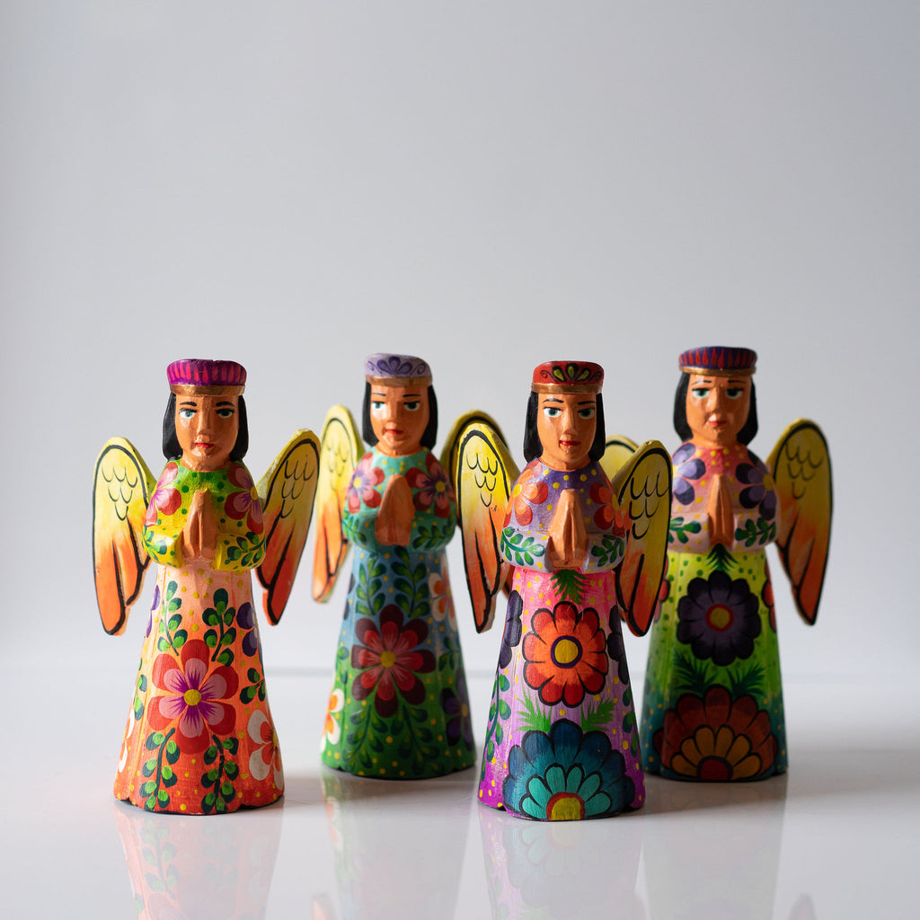 A group of 4 brightly painted floral Christmas tree topper angels. Hand carved with painted realistic faces.