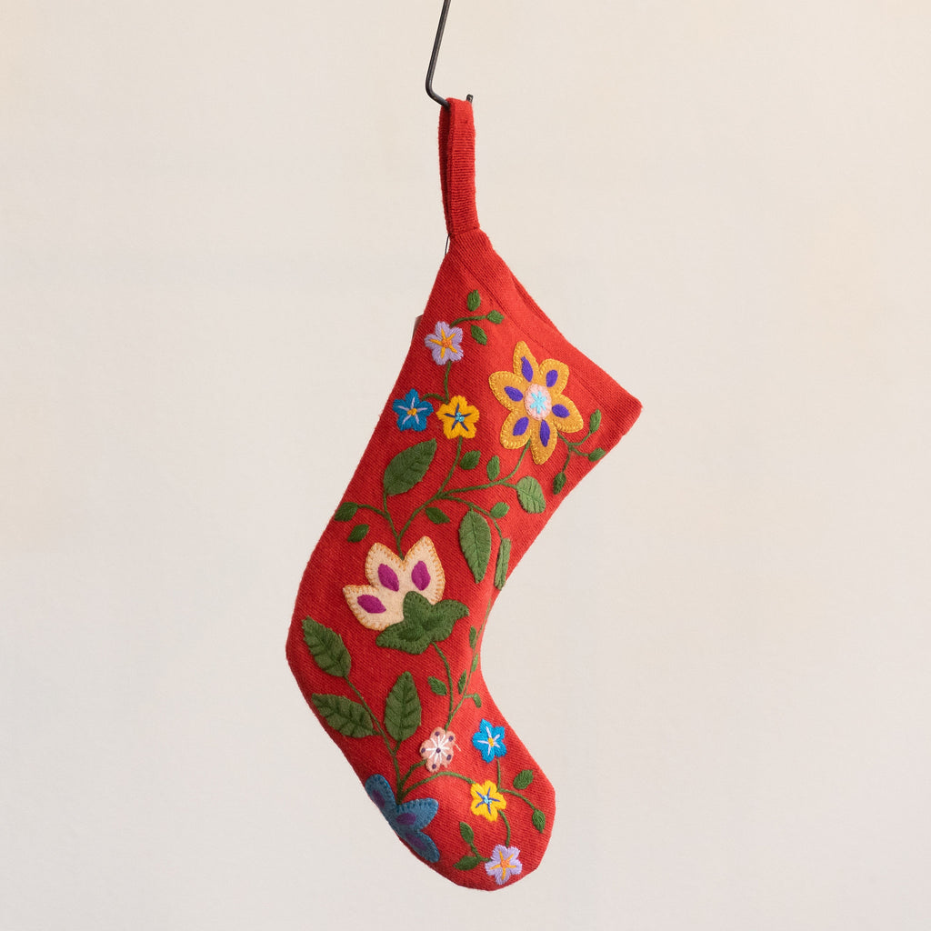 Red wool stocking with a bright and colorful embroidered Peruvian floral design.