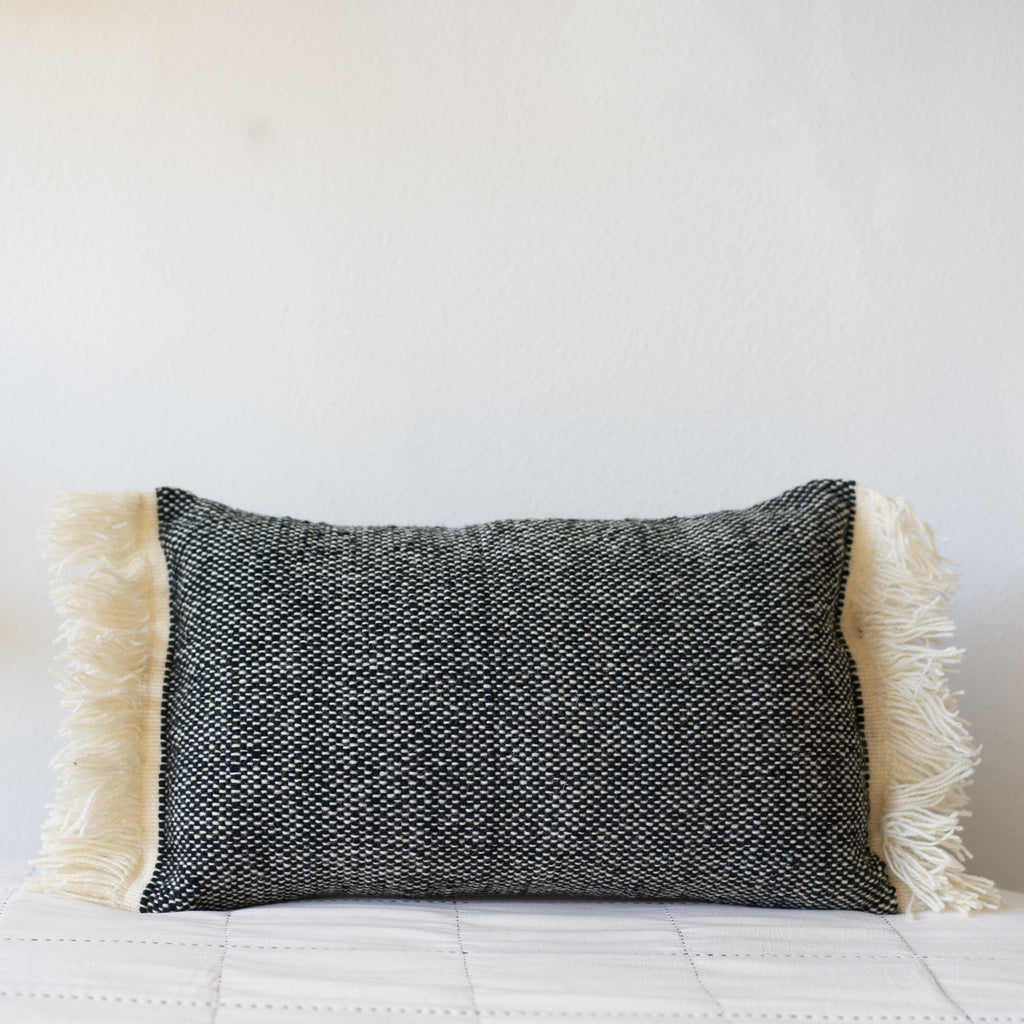 Black and cream wool tweed lumbar pillow with cream fringed edges.