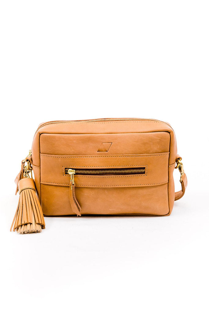 Tan leather rectangular purse with a leather strap with a big tan leather tassel. Back of purse with small zipper pocket.