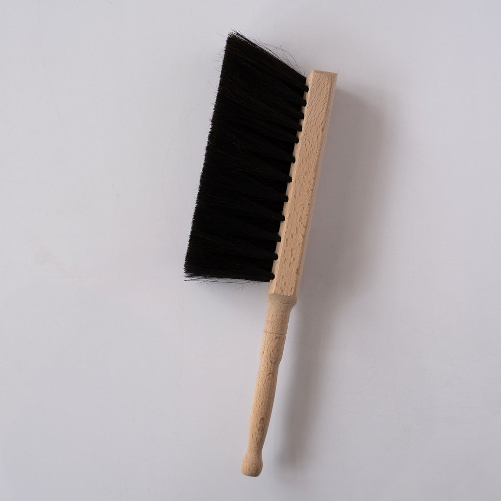 Beechwood handle and black horsehair brush on white background.