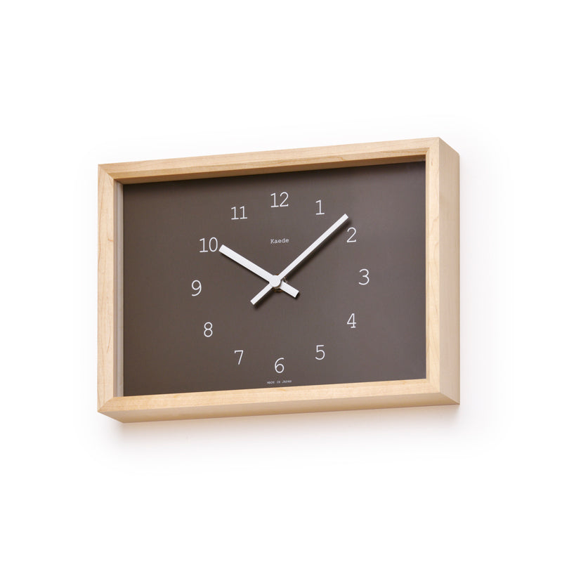 Warm brown rectangular clock face set in a rectangle maple frame. White numbers and hands. Clock hangs on a white wall. 