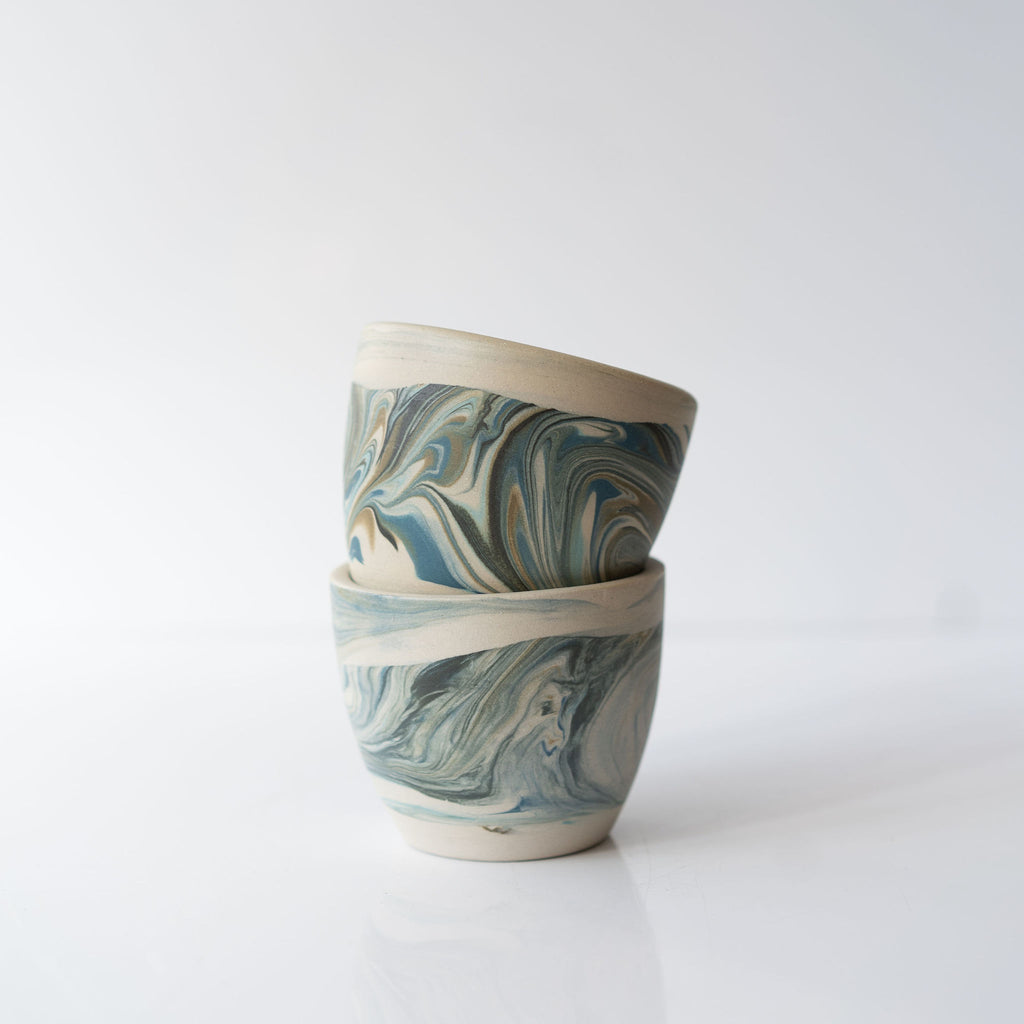 Stack of two blue marbled ceramic cups.