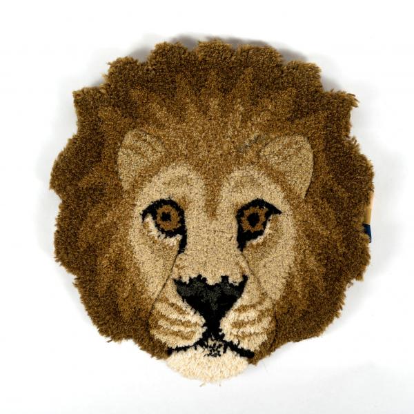 Hand-tufted wool rug shaped like a lion head laying flat on a white background. A beautifully crafted and detailed lion face.