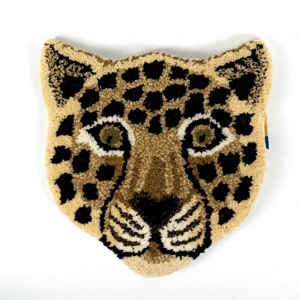 Hand-tufted wool rug shaped like a leopard head laying flat on a white background. A beautifully crafted and detailed leopard face.