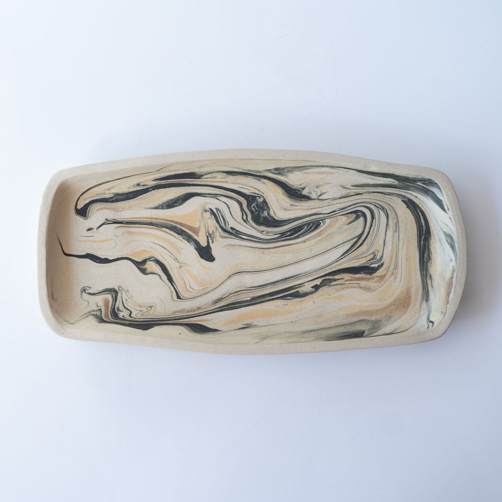 One black and tan marbled rectangular plate in shades with slightly raised edge.