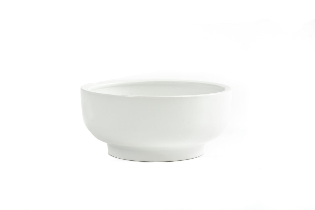 White porcelain bowl with slightly exaggerated pedestal on bottom.