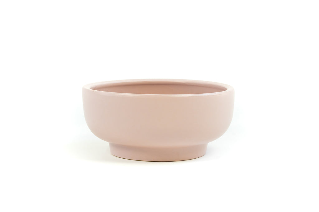 Blush Pink porcelain bowl with slightly exaggerated pedestal on bottom.