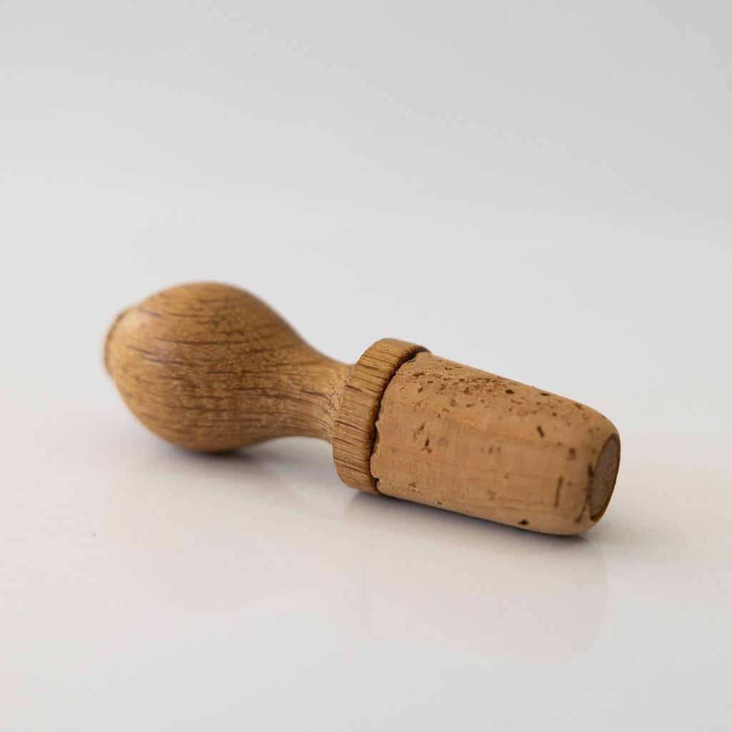 Natural cork and oak hand turned wine stopper.