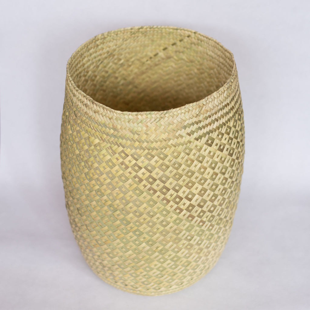 Tall handwoven palm fiber belly basket in traditional Oaxacan designs. Natural tans combine to create a subtle alternating diamond pattern. Interior of basket is natural tan. Gray background.