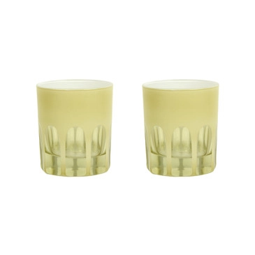 Pair of pale yellow toned handblown glasses with a mix of opaque and transparent arches along the bottom. White background.