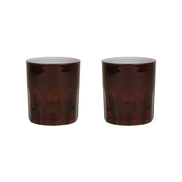Pair of amber toned handblown glasses with a mix of opaque and transparent arches along the bottom. White background.