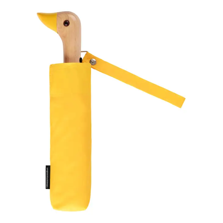 Yellow duckhead compact umbrella folded up on a white background.