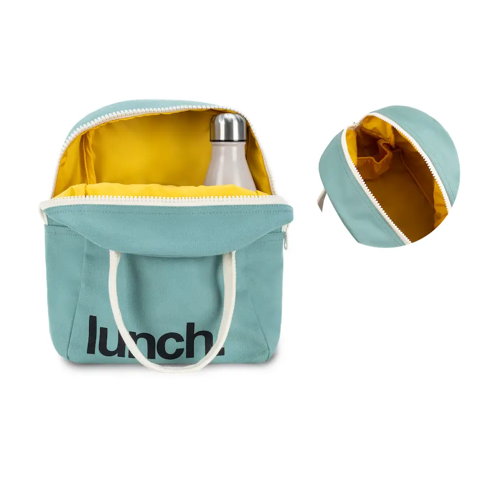 Soft sided teal cotton lunch bag with white canvas handles. Design is ‘lunch.’ printed in black on bottom left corner. Unzipped to show yellow interior with water bottle. White background.