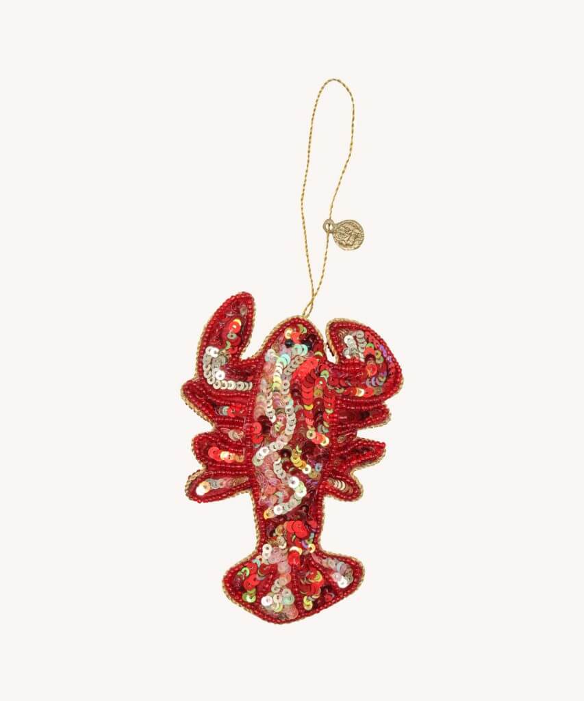 A bright red sequined lobster tree ornament on a white background.