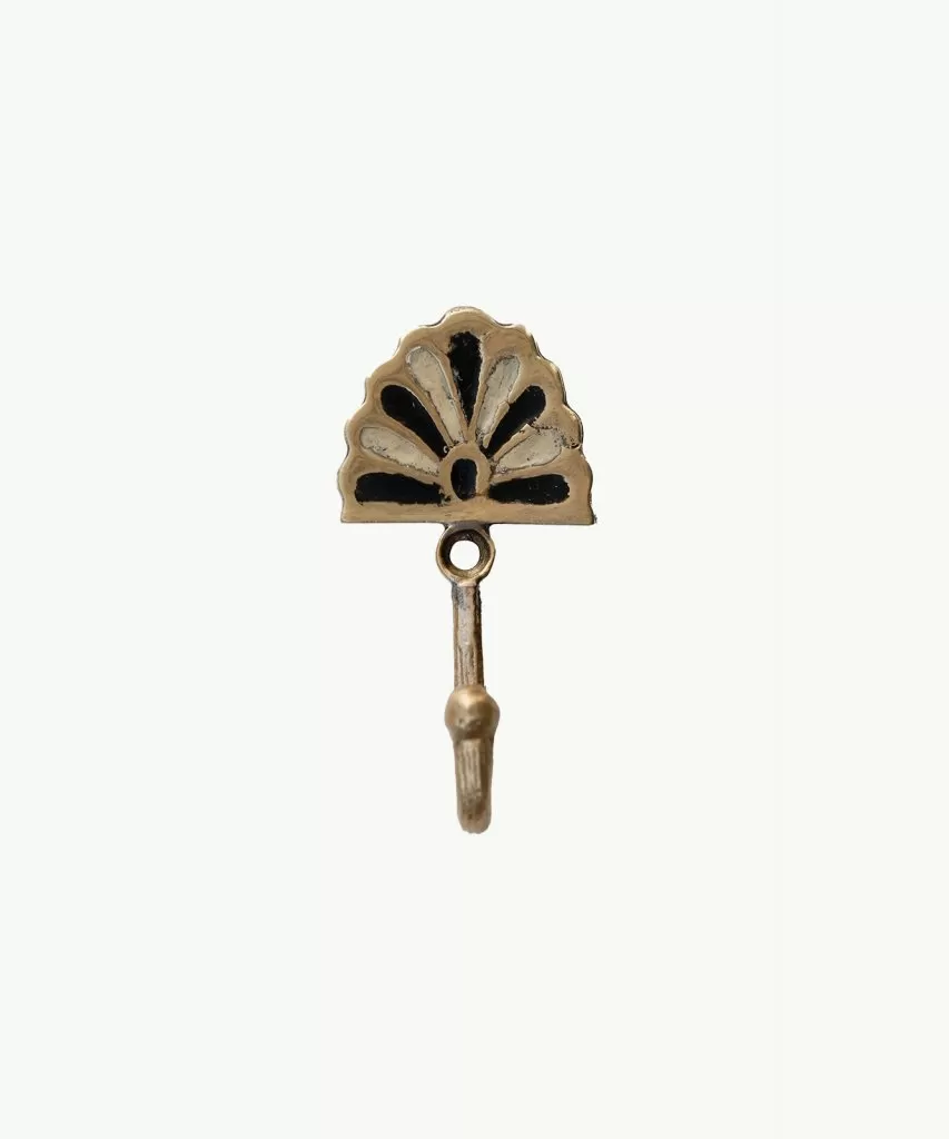Recycled brass hook with an art deco inspired petal fan on top. White background.