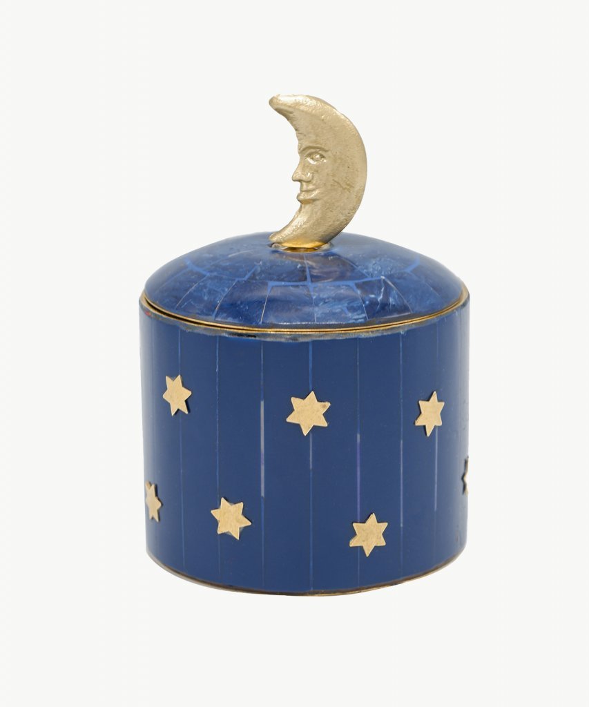 Dark blue and gold resin and brass round box. Brass stars around the outside of the base and a brass moon sits atop the lid.